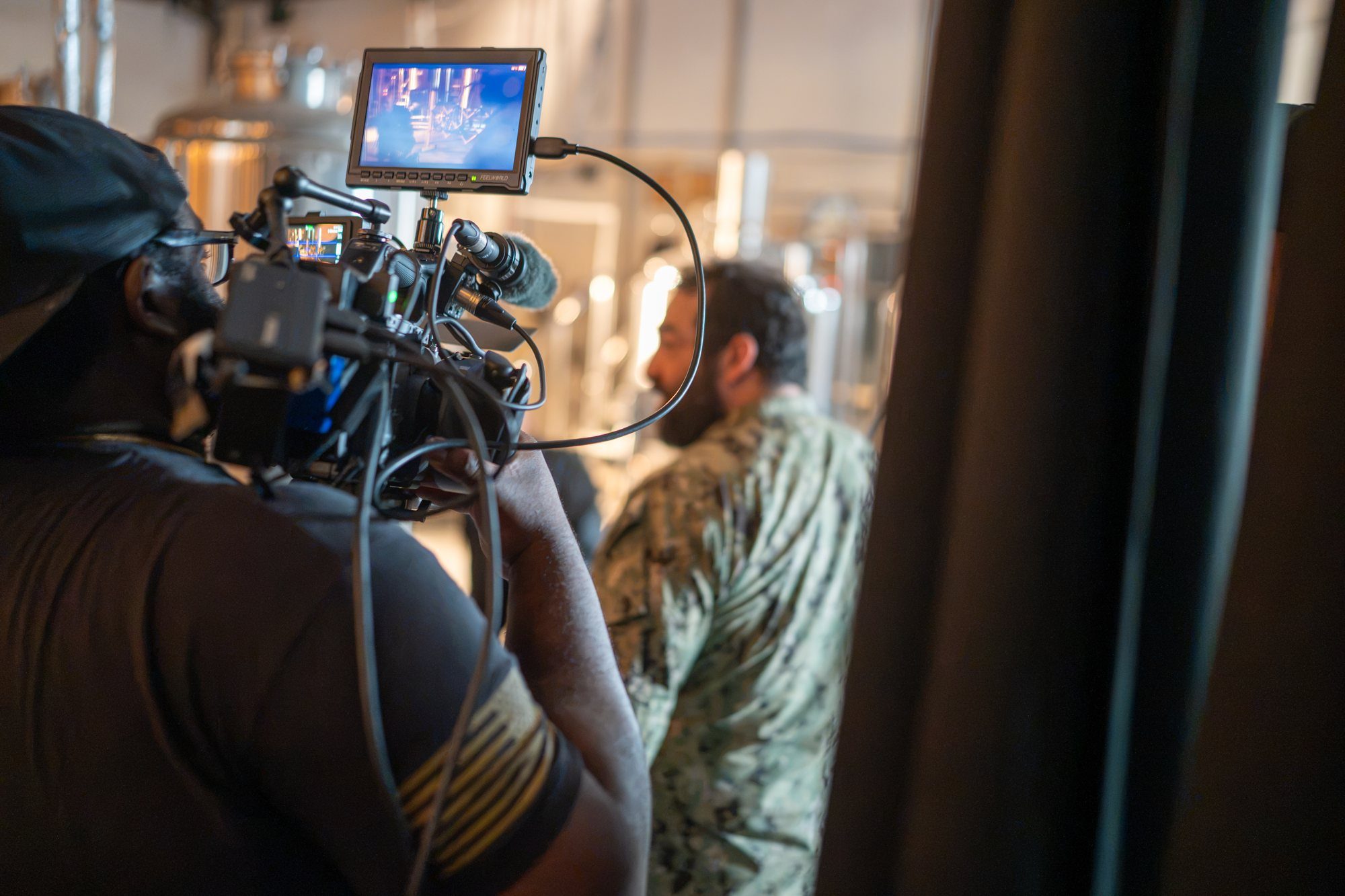 A veteran operating camera on a Light Inside Cinema set